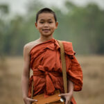 Novice monks walking in the meadow